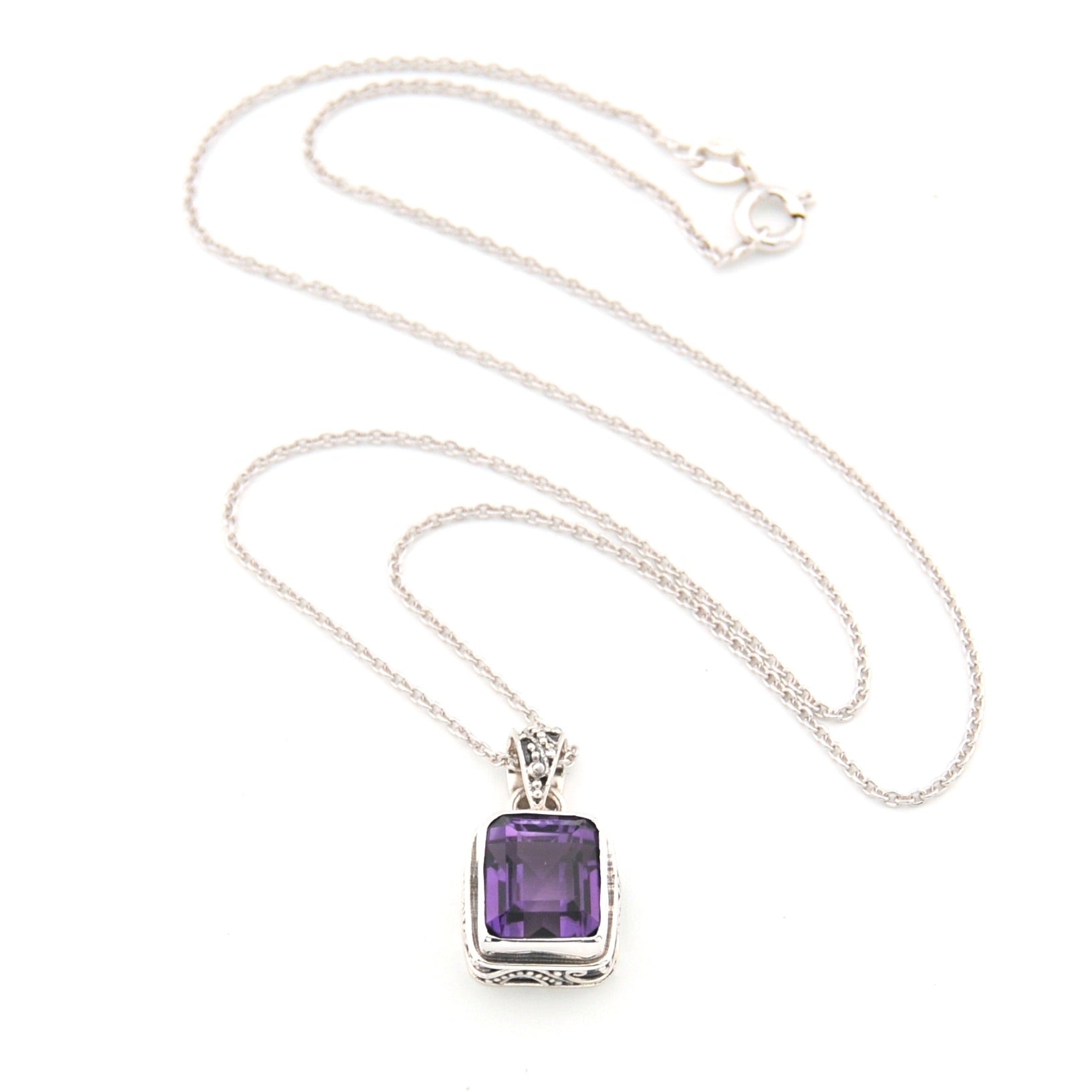 Necklace with a purple gemstone pendant on a white background
