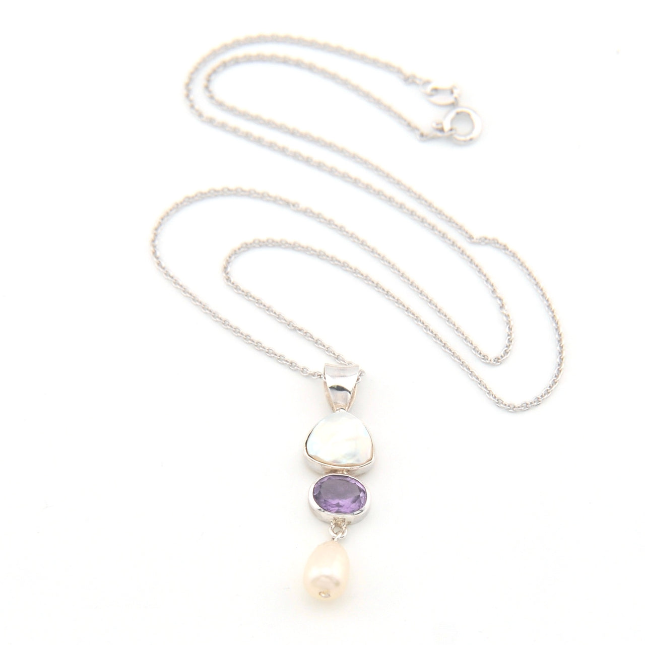 Necklace with a pendant featuring a purple gemstone and pearl on a white background