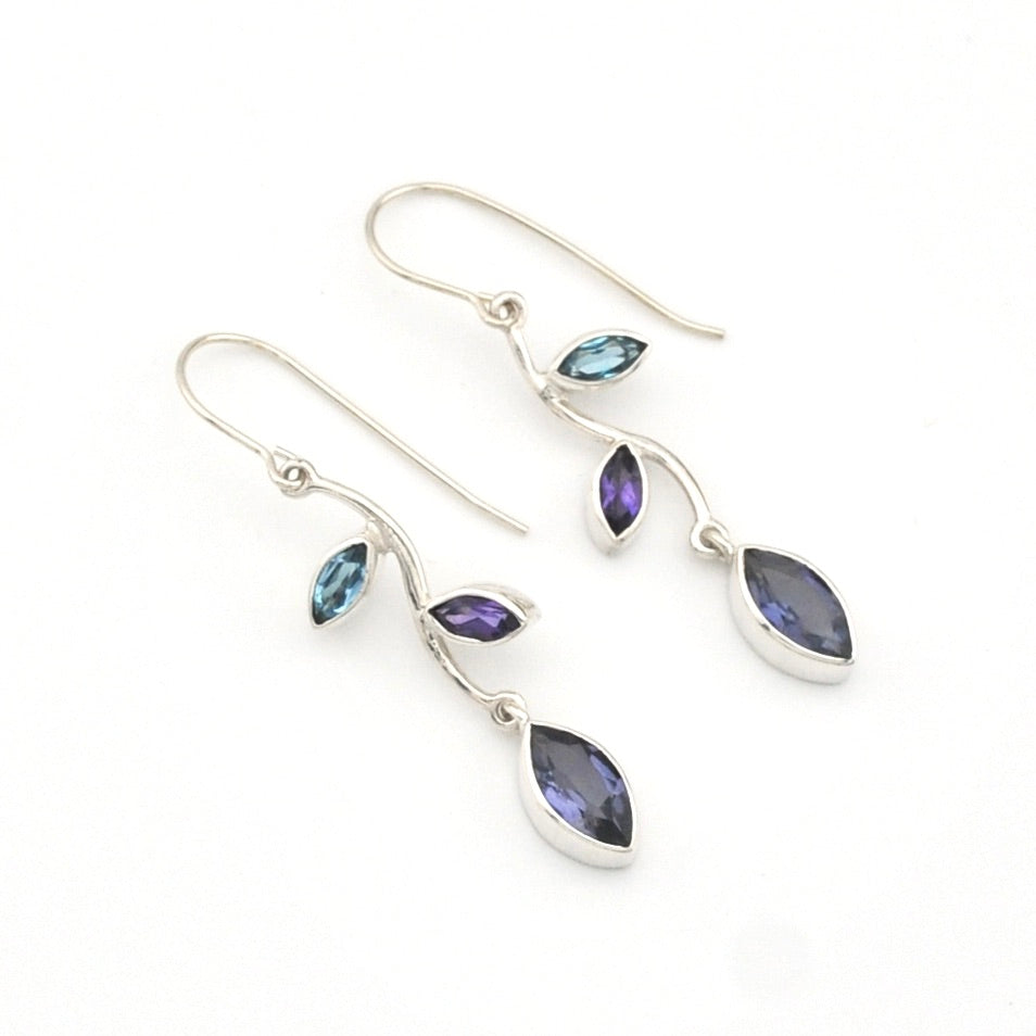 Silver earrings with blue and purple gemstones on a white background