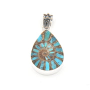 Teardrop-shaped pendant with floral design and silver setting on a white background