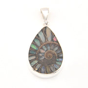 Teardrop-shaped pendant with multicolored stone and silver setting on a white background