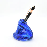 Blue glass pen holder with a black pen on a white background