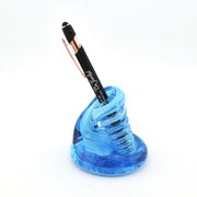 Blue spiral pen holder with a black pen on a white background