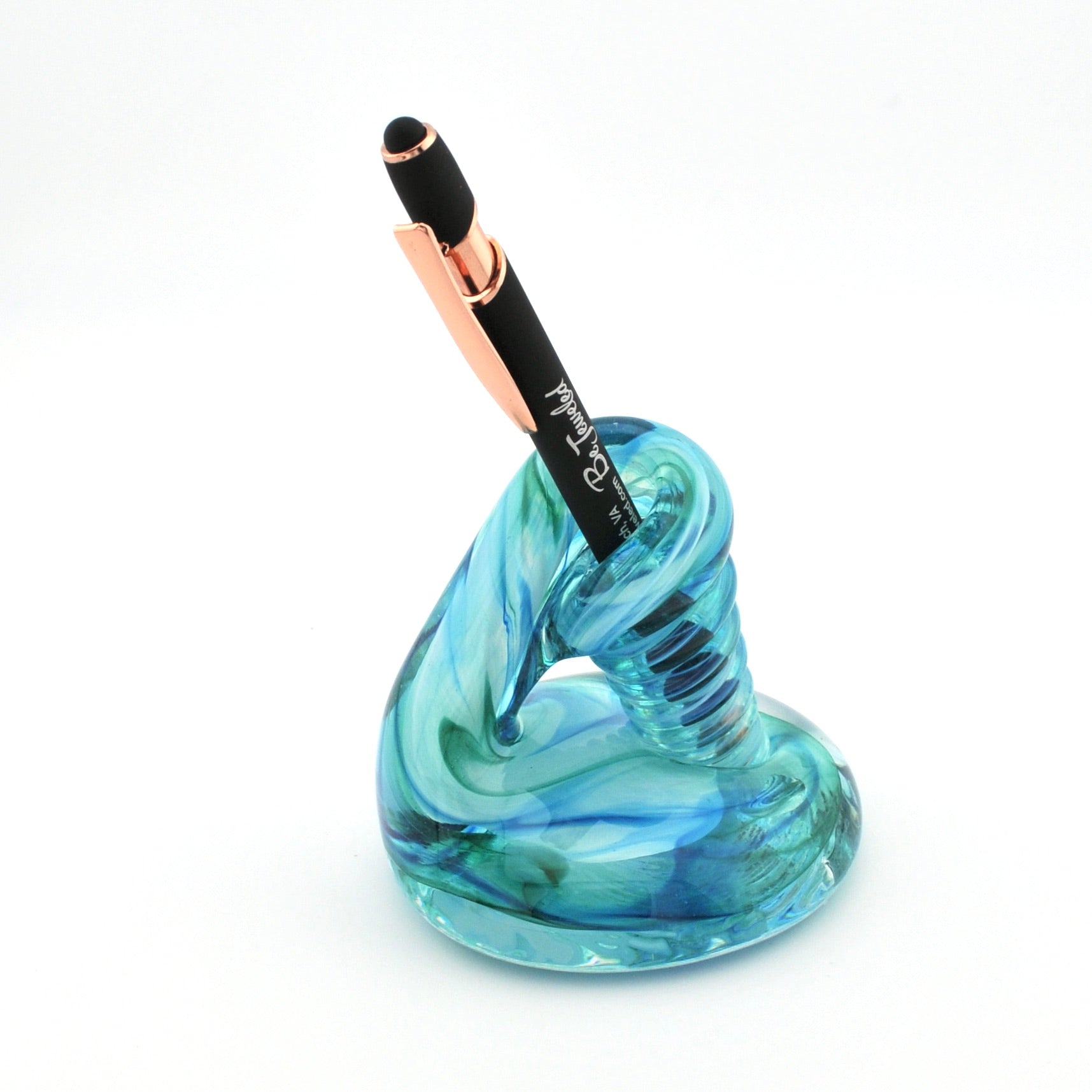 Blue glass pen holder with a black and rose gold pen on a white background