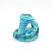 Blue and green glass spiral object on a white background