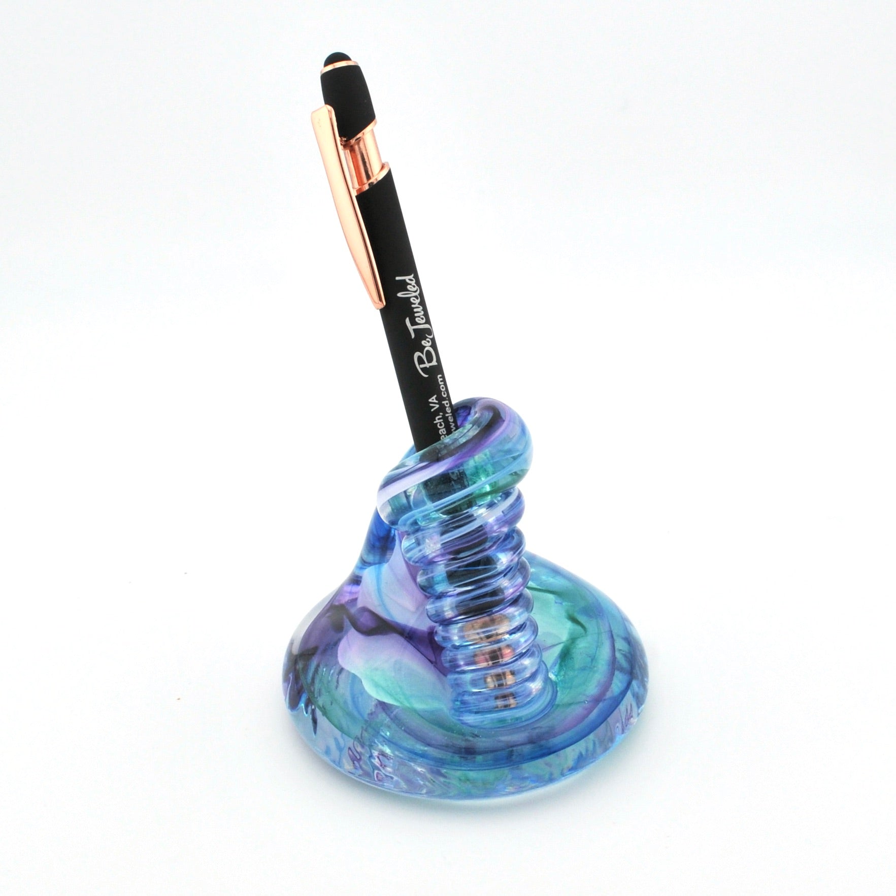 Blue glass pen holder with a black pen on a white background