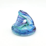 Glass object with blue and green swirl design on a white background