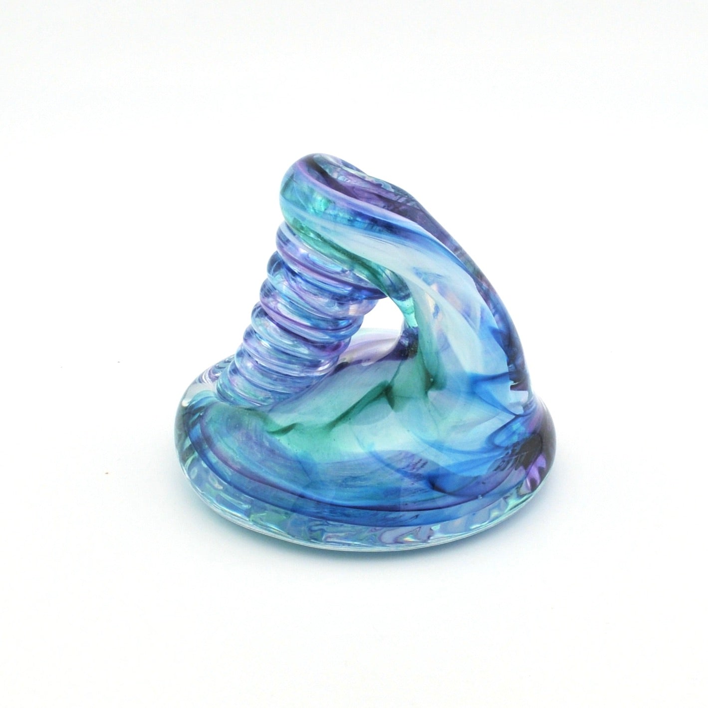Glass object with blue and green swirl design on a white background
