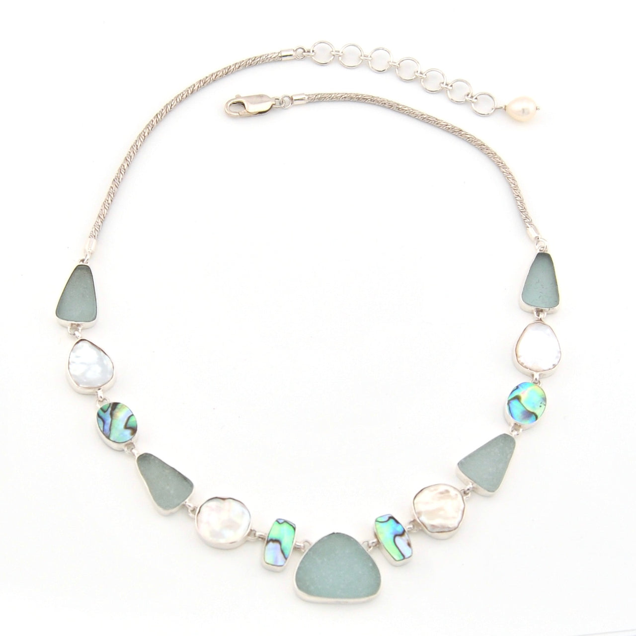 Necklace with green and silver beads on a white background