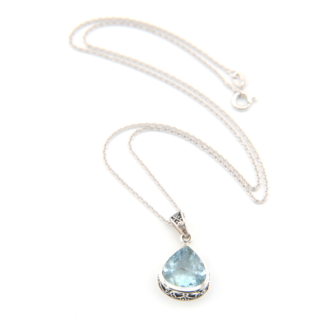Necklace with a teardrop-shaped blue gemstone pendant on a white background