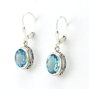 Side View Sterling Silver Blue Topaz 8x10mm Oval Bali Dangle Earrings