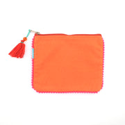 Orange pouch with pom-pom trim and tassel on a white background