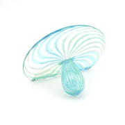 Glass sculpture with swirling pattern on a white background