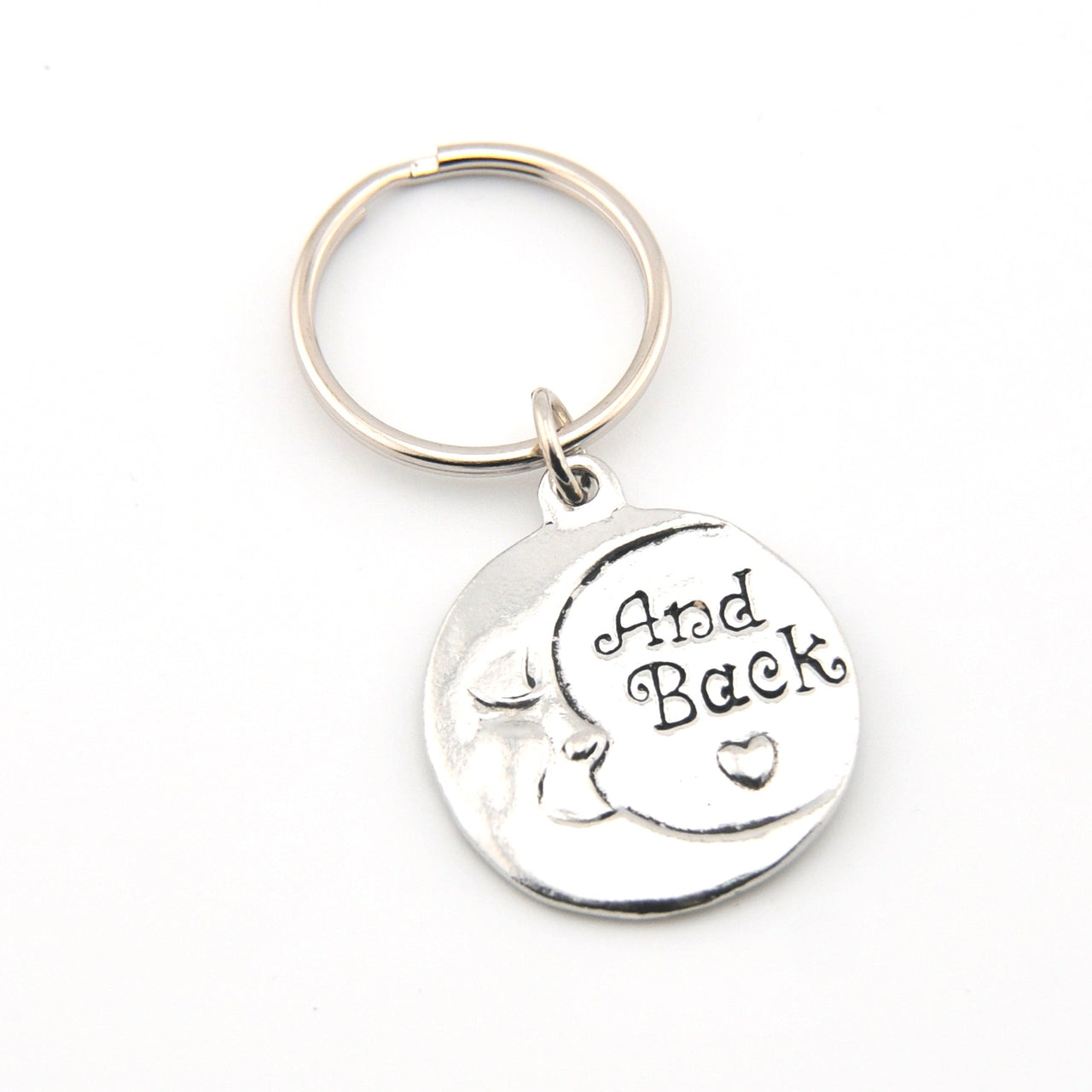 Silver keychain with 'And Back' engraving on a white background
