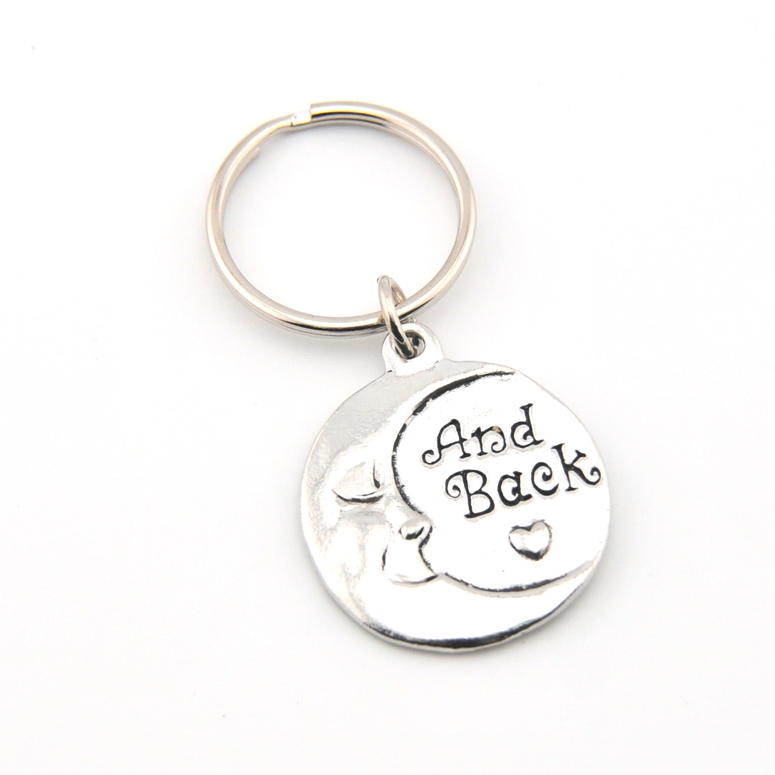Silver keychain with 'And Back' engraving on a white background