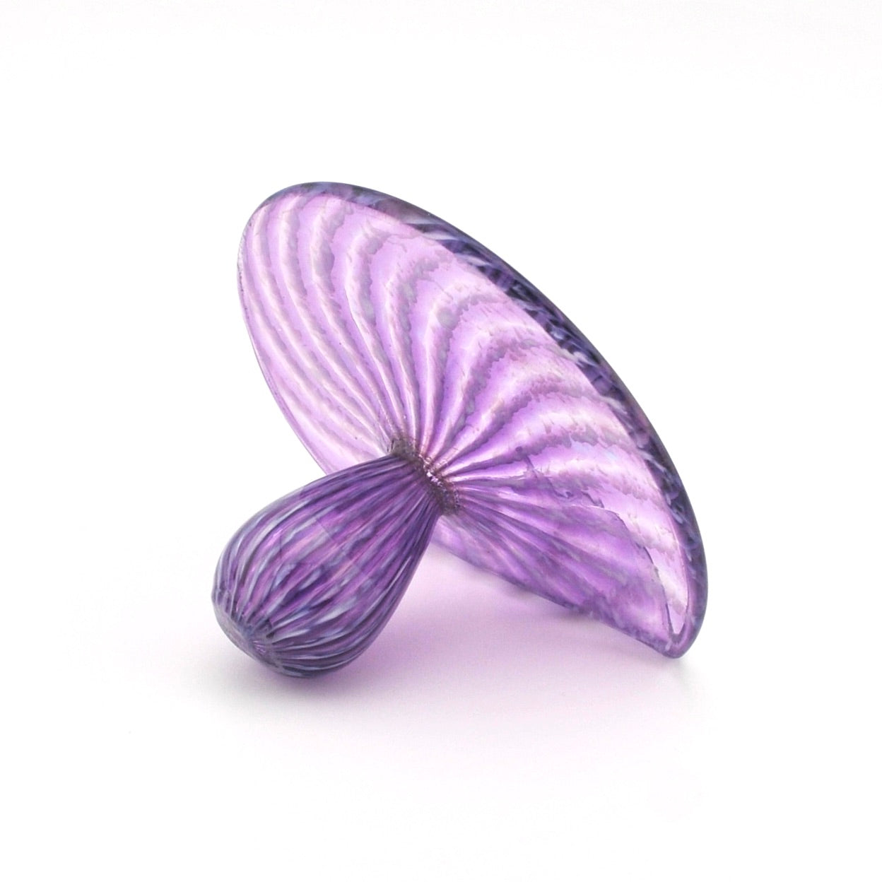 Purple glass object with wavy design on a white background