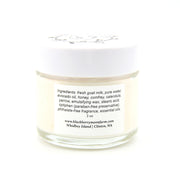 Jar of cream with a white lid on a white background