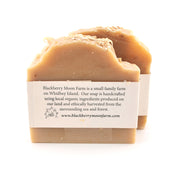 Two bars of soap with a label on a white background, featuring information about Blackberry Moon Farm.