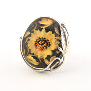 Ring with sunflower design on a black background