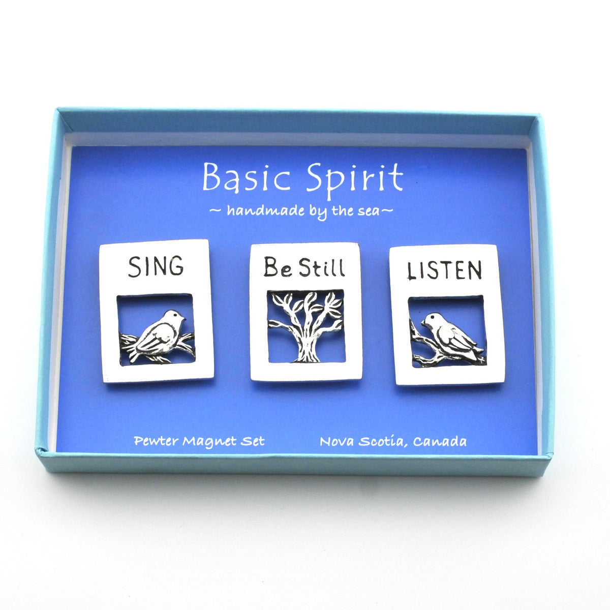 Three magnets featuring birds with the words sing, be still and listen in blue box on a white background.