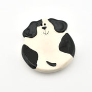 Dog-shaped dish with black and white design on a white background
