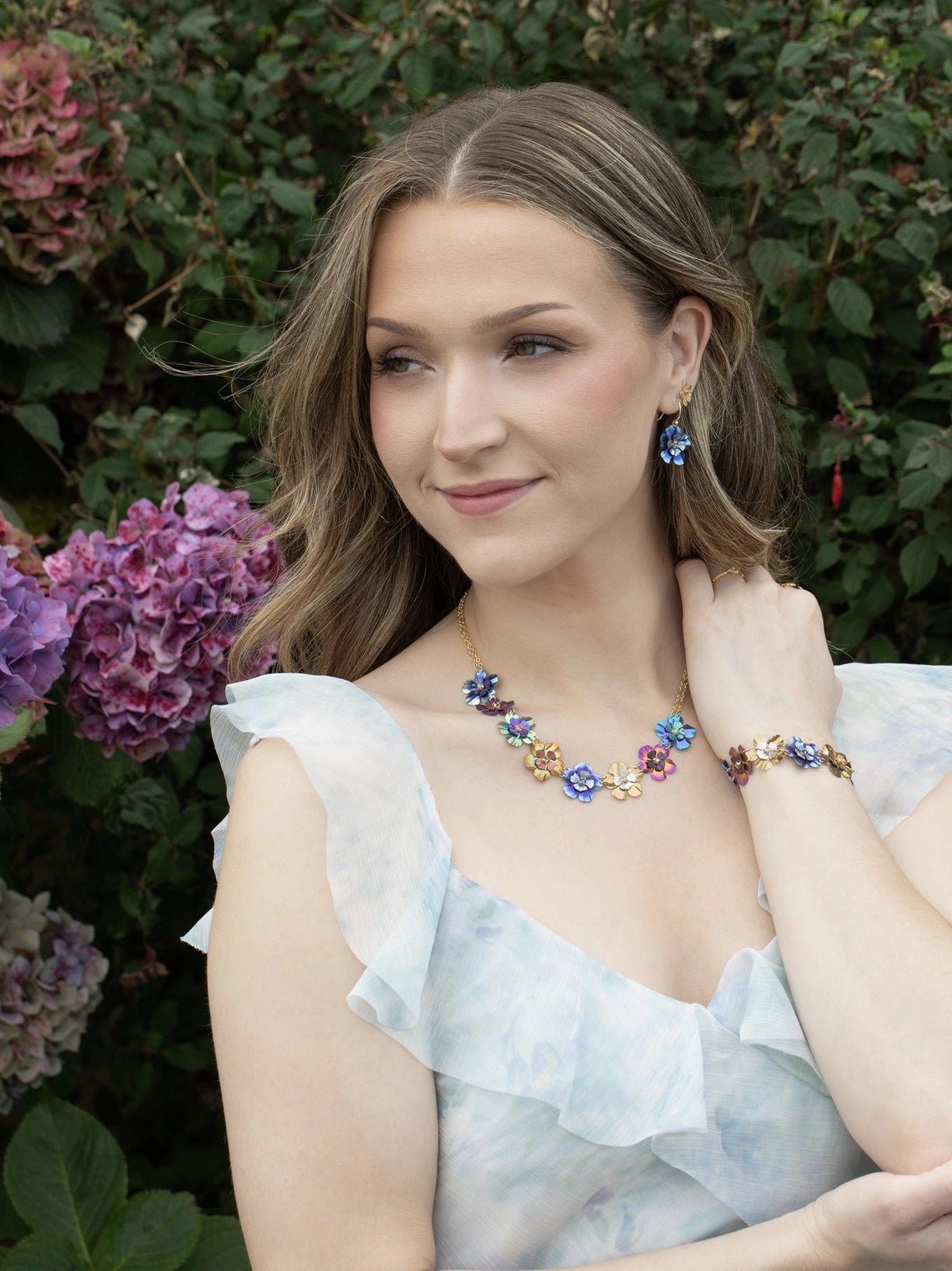 Woman wearing colorful jewelry against a floral background