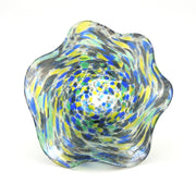 Colorful glass bowl with swirl pattern on a white background