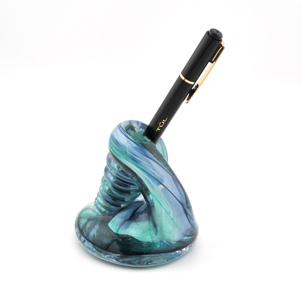 Blue and green glass pen holder with a black pen on a white background