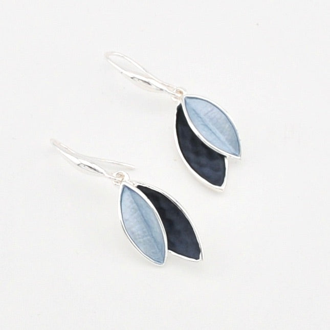 Pair of earrings with blue and black leaf-shaped stones on a white background