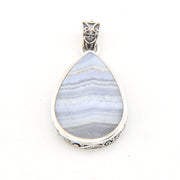 Teardrop-shaped pendant with blue pattern and silver frame on a white background
