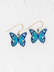 Blue butterfly earrings on a white background