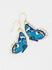 Blue butterfly earrings with gold accents on a white background