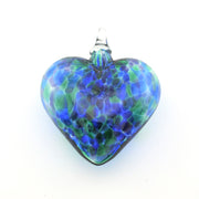 Glass heart ornament with blue and green pattern on a white background