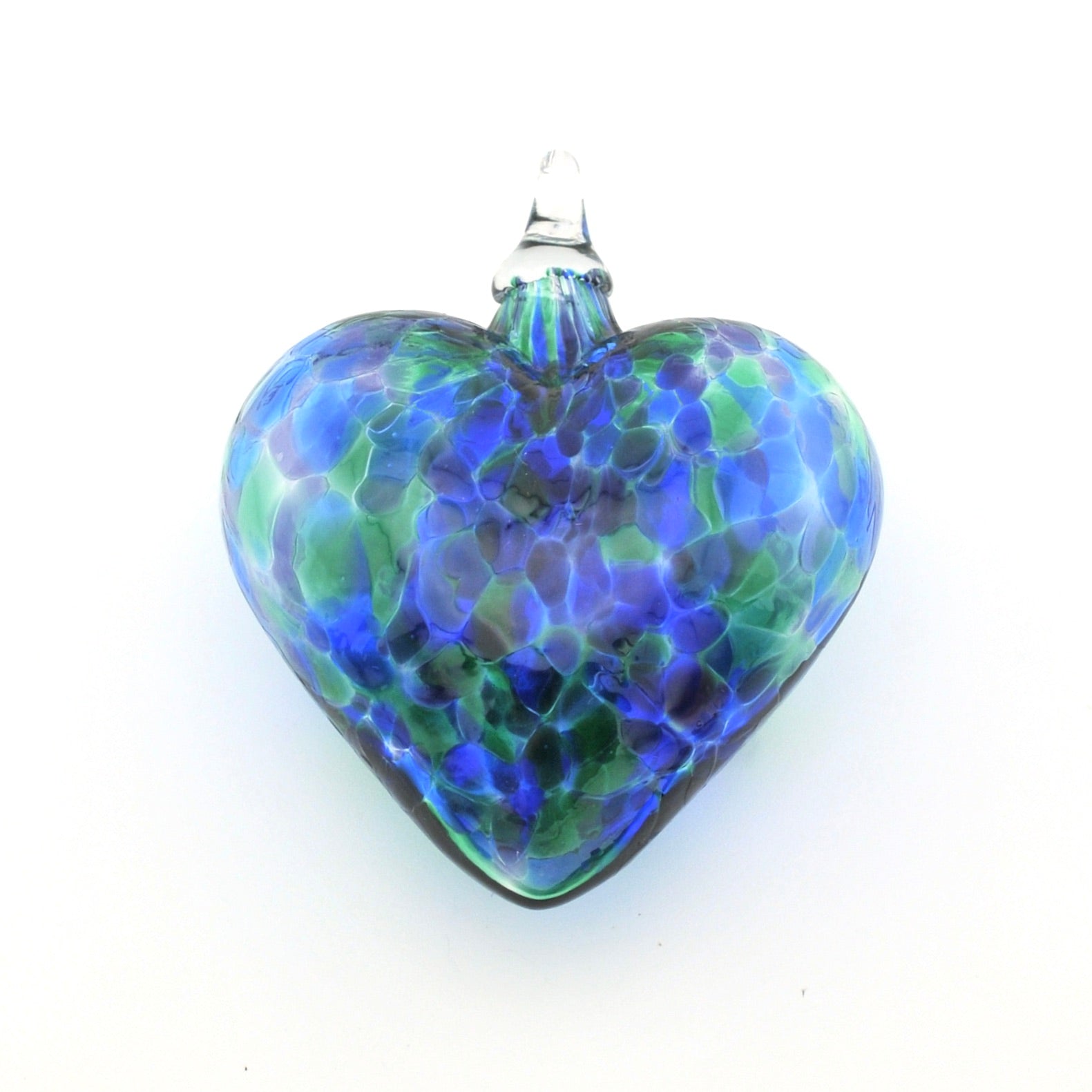Glass heart ornament with blue and green pattern on a white background