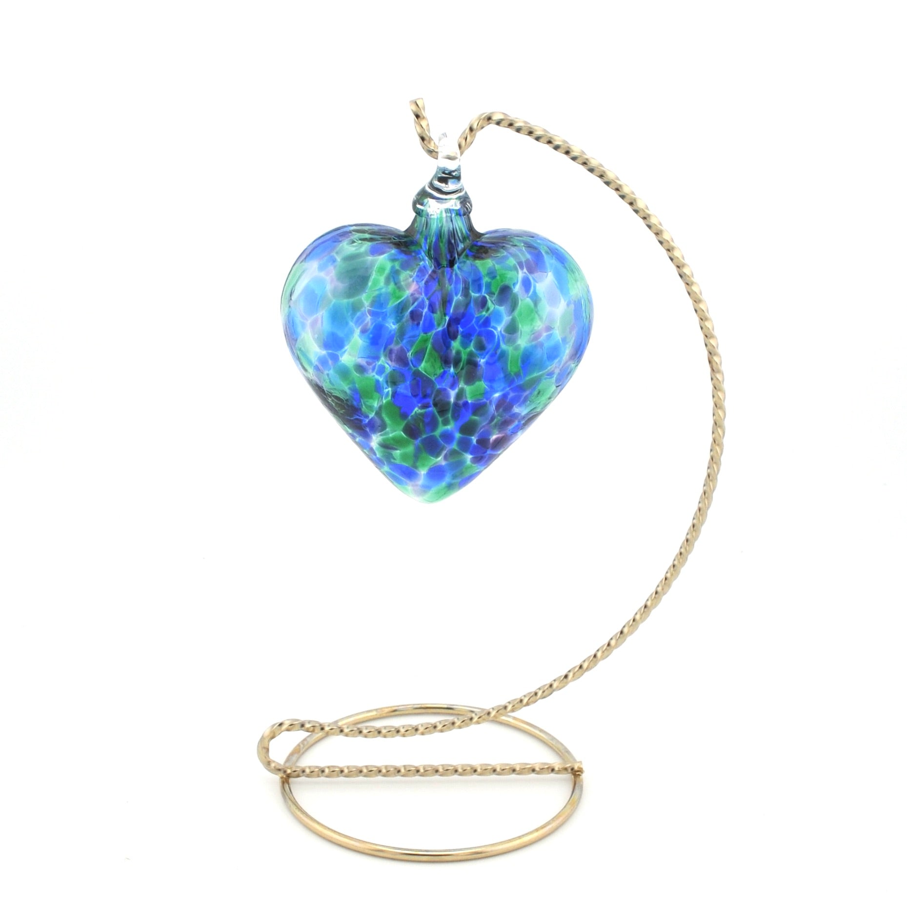 Heart-shaped blue and green glass ornament on a gold chain against a white background