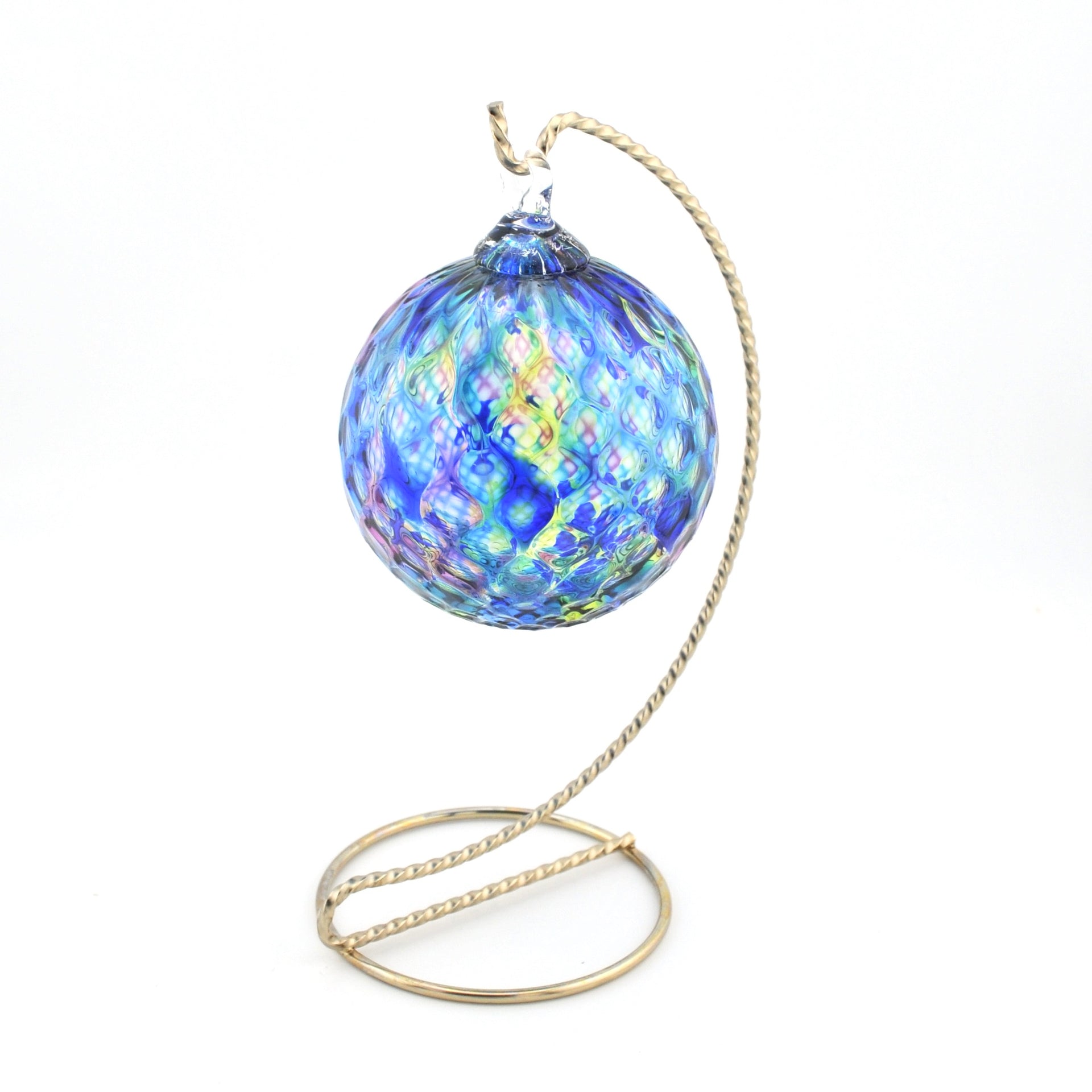 Decorative glass ball with a gold stand on a white background
