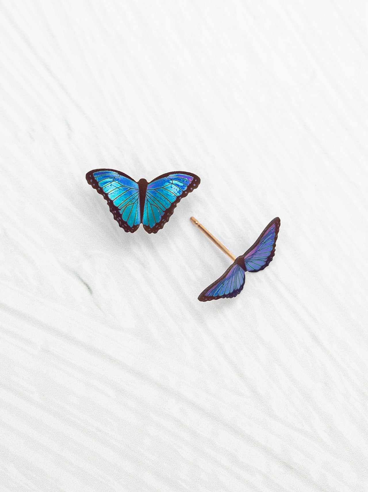 Butterfly-shaped earrings on a white background
