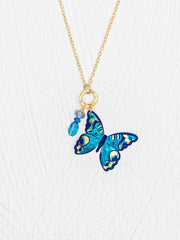 Necklace with a blue butterfly pendant on a white background
