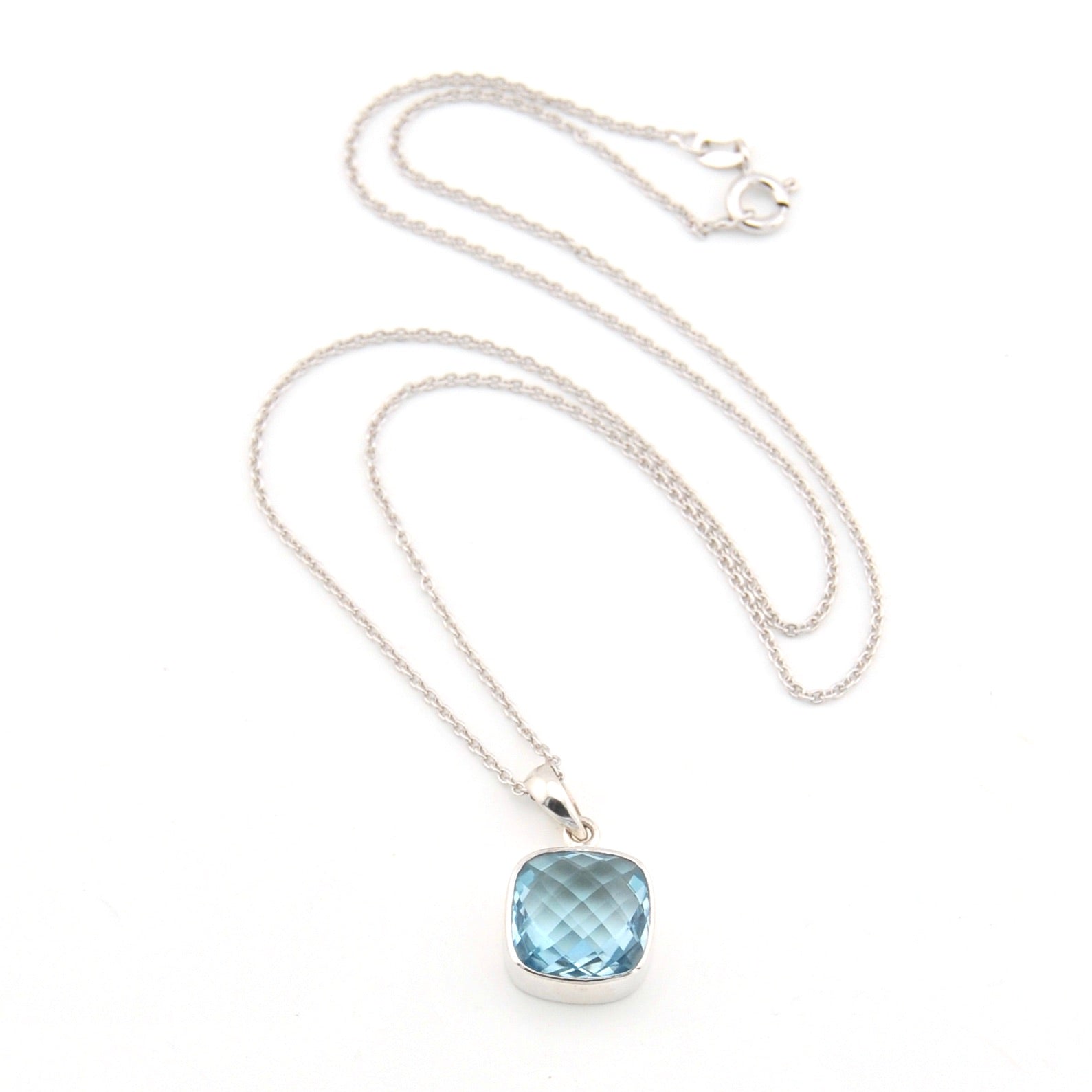 Necklace with a blue gemstone pendant on a white background