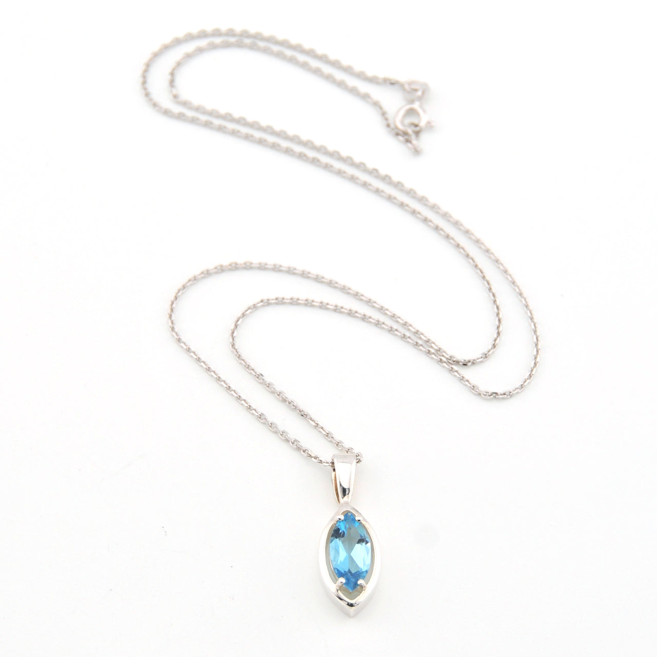 Silver necklace with a blue gemstone pendant on a white background