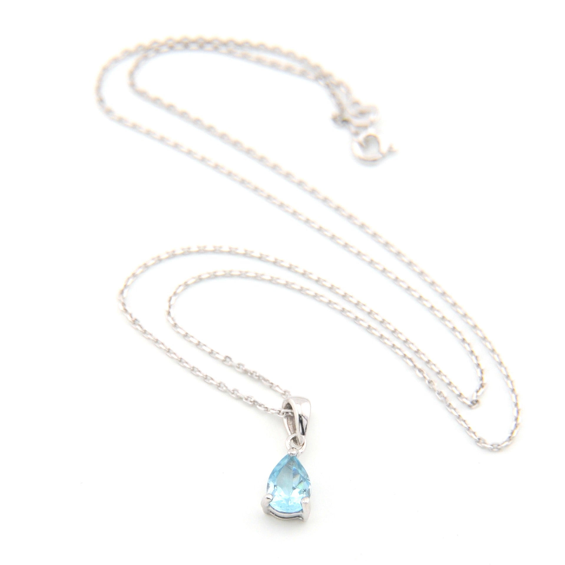 Necklace with a teardrop-shaped blue gemstone pendant on a white background