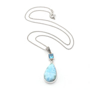 Necklace with a teardrop-shaped larimar pendant on a white background