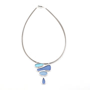 Silver necklace with blue pendant on a white background