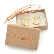 Gold hoop earrings in a 'Be Jeweled' box on a white background