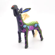 Colorful burro figurine with abstract patterns on a white background