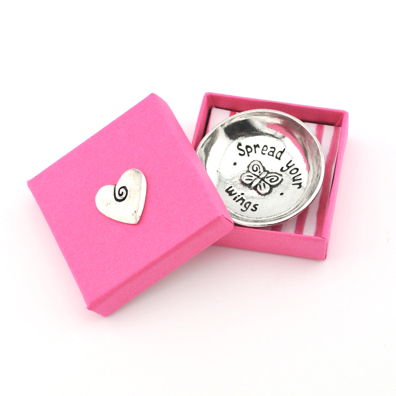 Silver trinket dish with 'Spread your wings' text and heart-shaped object in a pink box