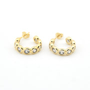 Gold hoop earrings with embedded stones on a white background