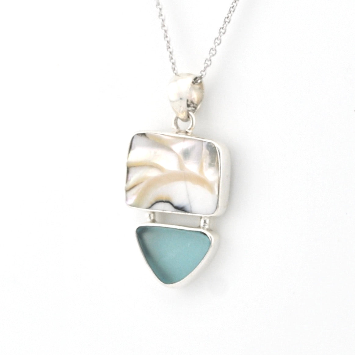 Necklace with a square pendant featuring a mother-of-pearl design and a green sea glass piece on a white background.