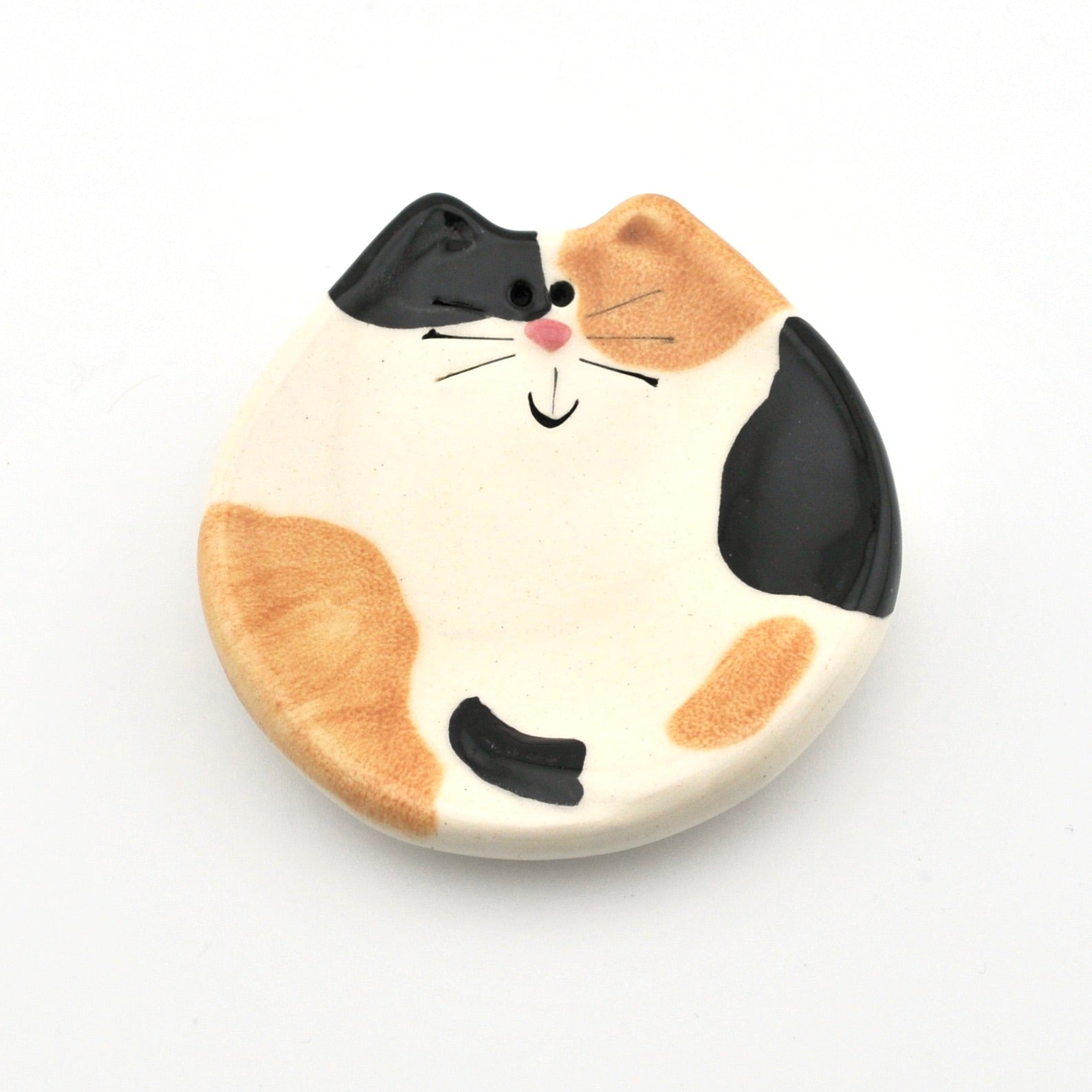 Cat-shaped ceramic dish with a white background
