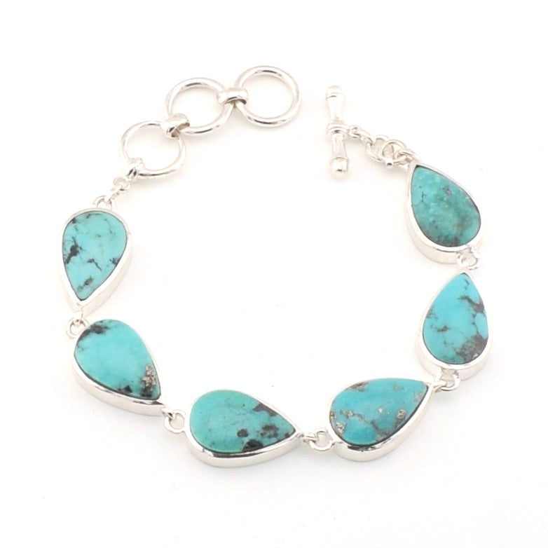 Turquoise teardrop bracelet with silver links on a white background